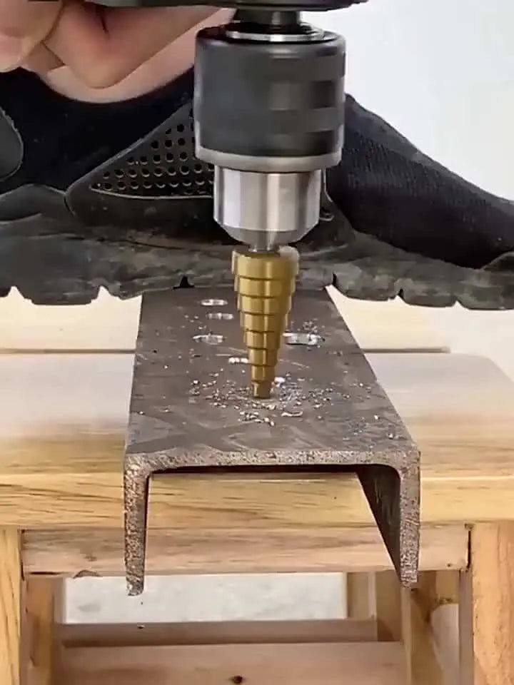 3 piece titanium coated drill bits drilling metal surface.