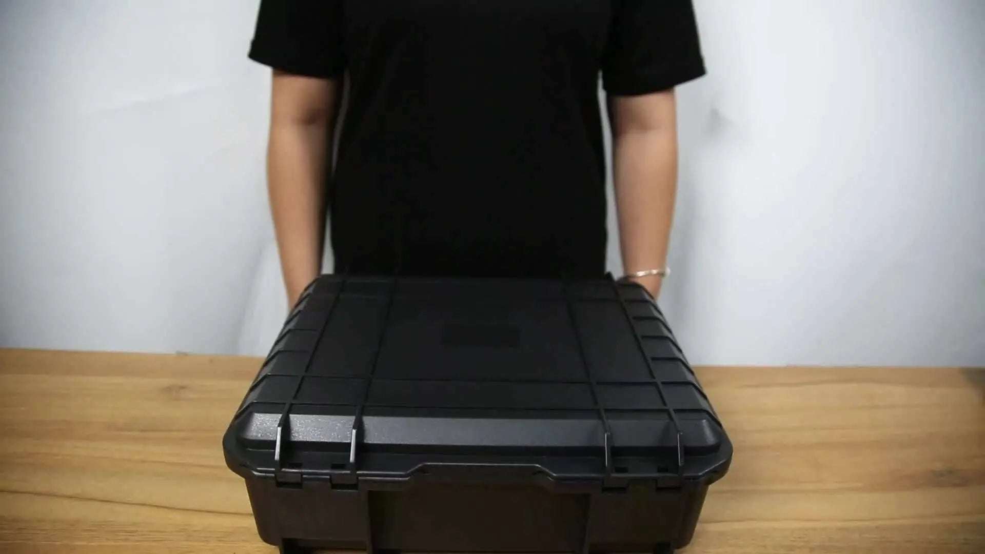 Explosion and waterproof hard shell case for DJI Mini 4 Pro on wooden table.