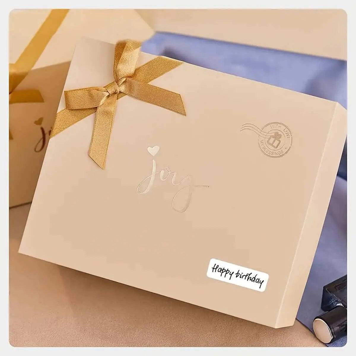 Portable wireless thermal label printer used to create a "Happy Birthday" label on a gift box.