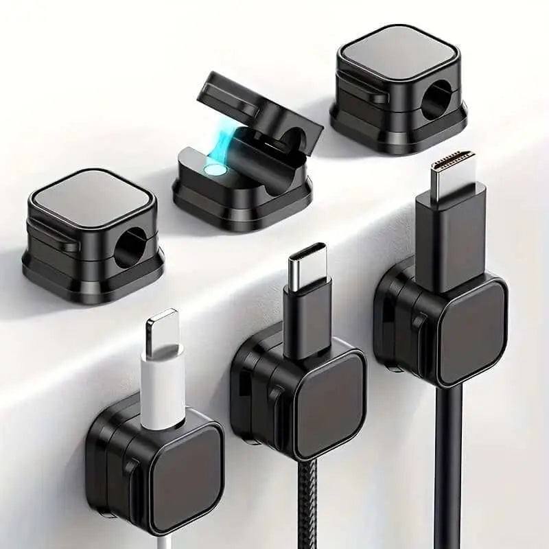 Magnetic charging cable clips organizing various cables on a desk surface.