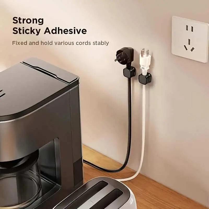 Adjustable magnetic charging cable clips organizing cords on a wall.