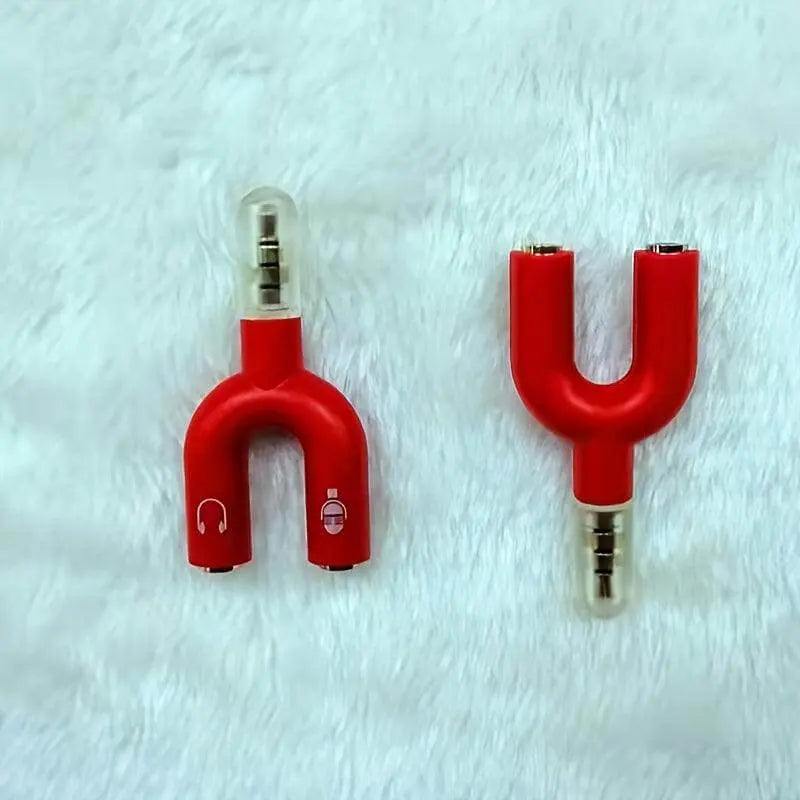 Red headphone jack splitter with dual 3.5mm connectors for audio and mic outputs.