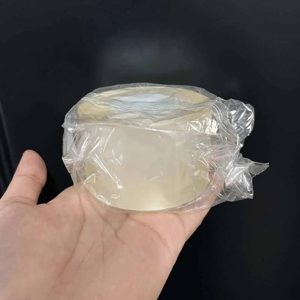Nano Double-Sided Tape roll held in hand, ideal for mounting and organizing on various surfaces.