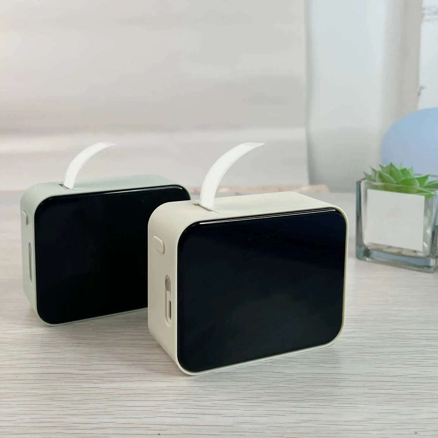 Portable wireless thermal label printer on a desk.