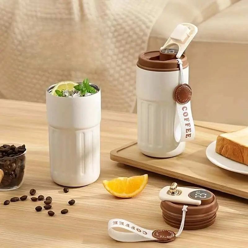 Stainless steel insulated coffee cup with digital display and matte finish.