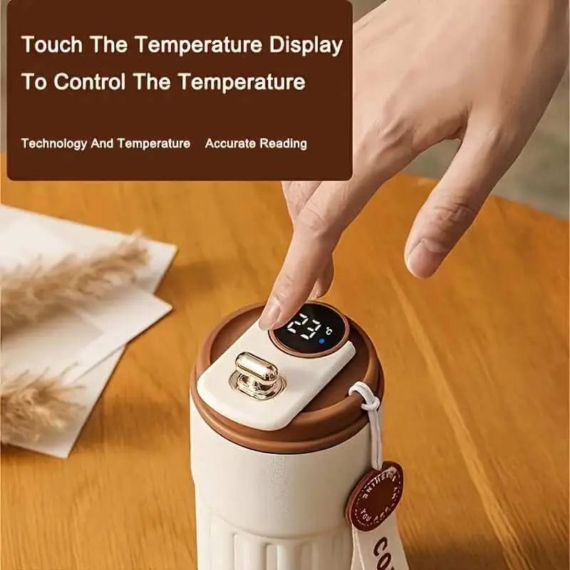 Stainless steel insulated coffee cup with digital temperature display and matte finish.